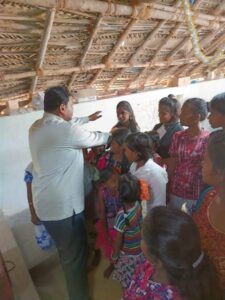 Pastor Vincent Sekhar praying over children
